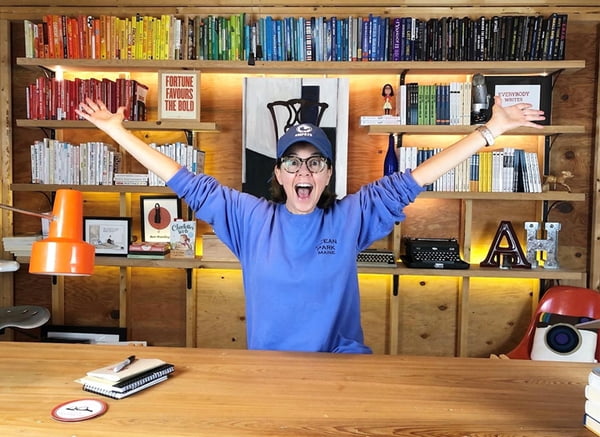 Ann in her Tiny House office with books