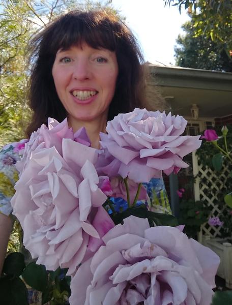 Mauve Charles de Gaulle roses and me in our front garden