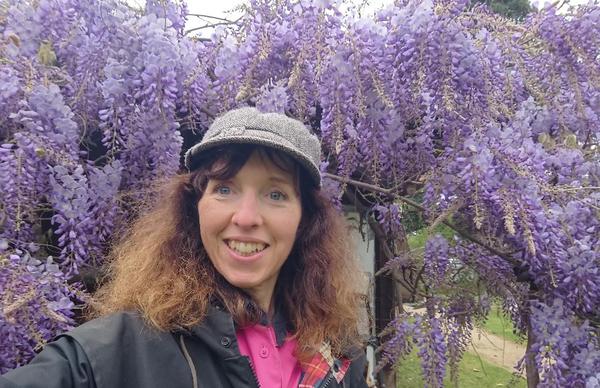 Me in front of a 90 year old purple wisteria vine.