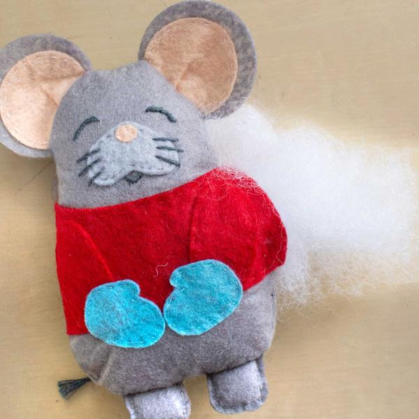 plush mouse with stuffing sticking out the side