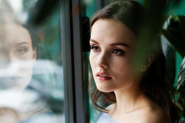 woman with reflection in window