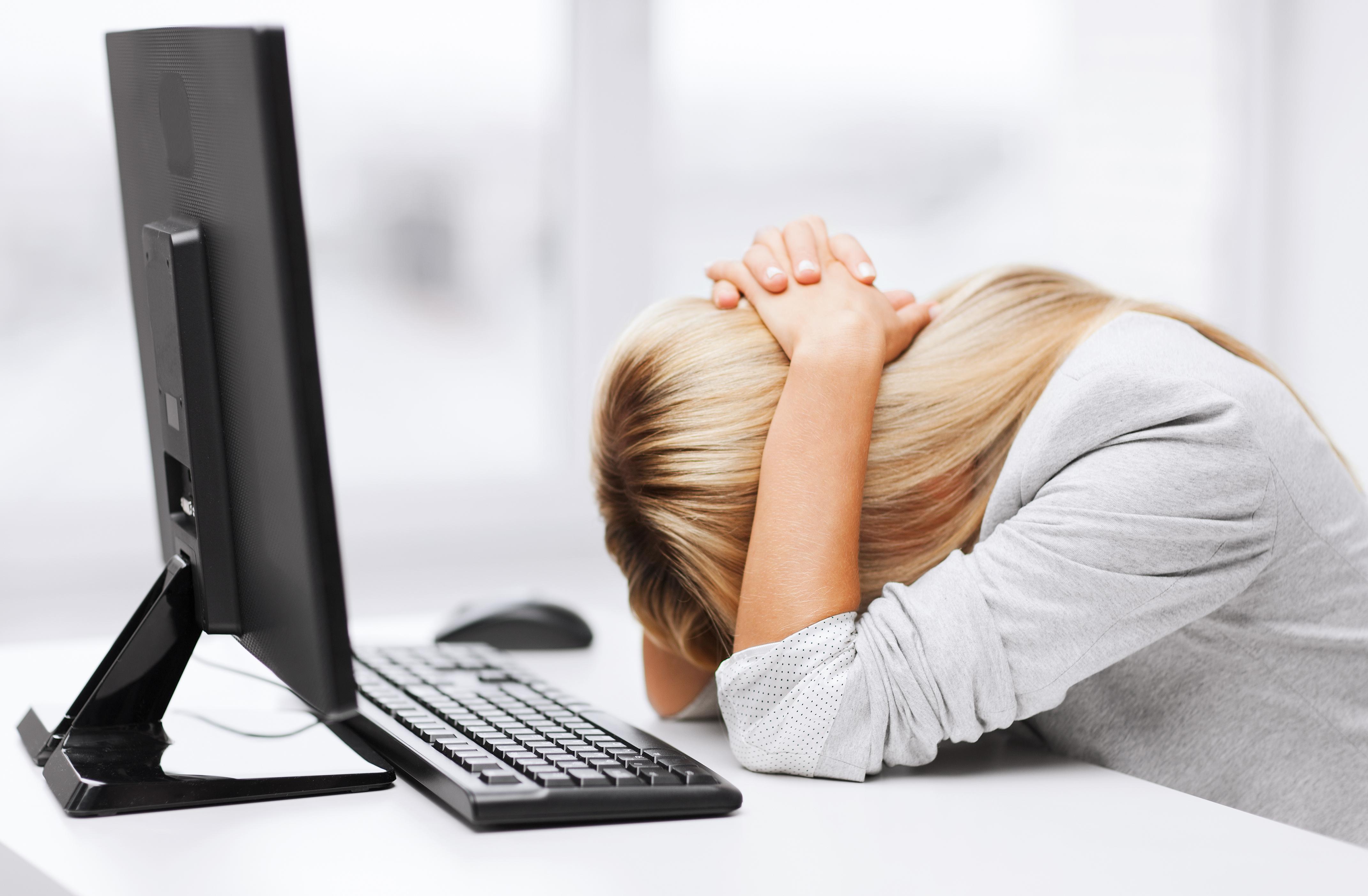 overwhelmed woman at computer