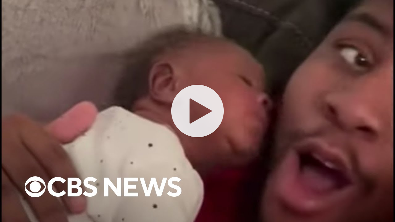 Newborn surprises dad with kiss
