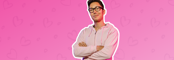 Man with his arms crossed with a heart background