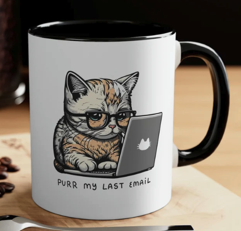 White coffee mug with black handle with image of cat at a laptop and text “Purr my last email”