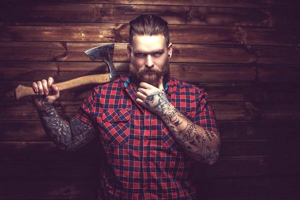 A mythic lumberjack with an axe and tattoos. 