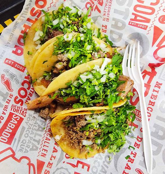 Tacos on a paper plate. 