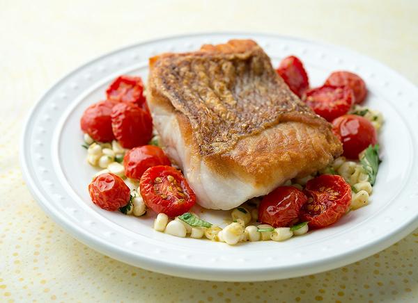 Seared fish with corn and cherry tomatoes. 