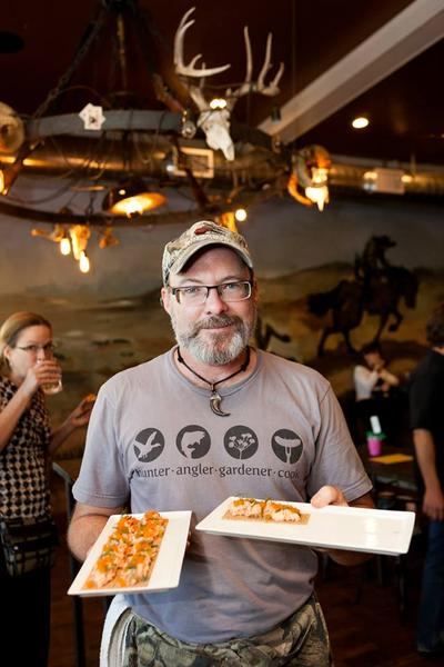 Hank Shaw serving food. 