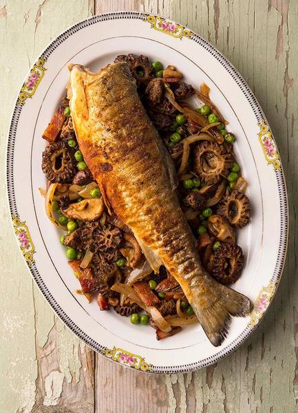 A plate of trout with morel mushrooms