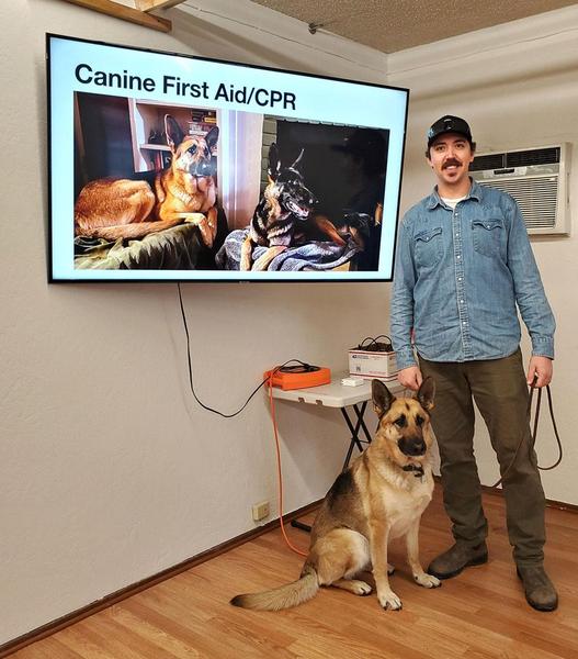 A dog and his human friend at a canine first aid course