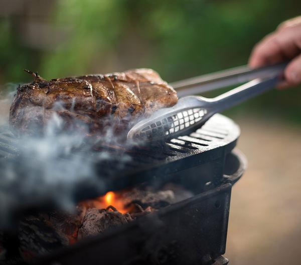 Grilling venison backstrap on a hibachi.