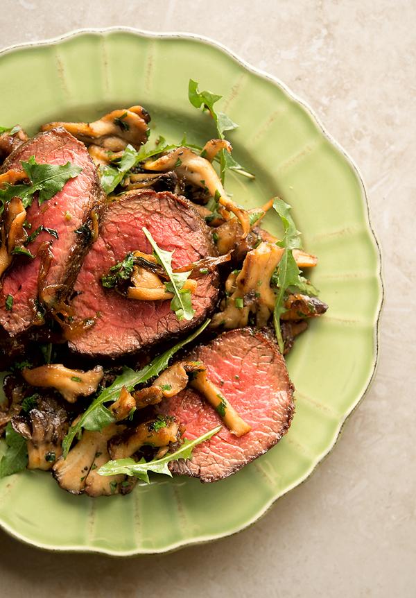 A venison steak with caramelized mushrooms. 