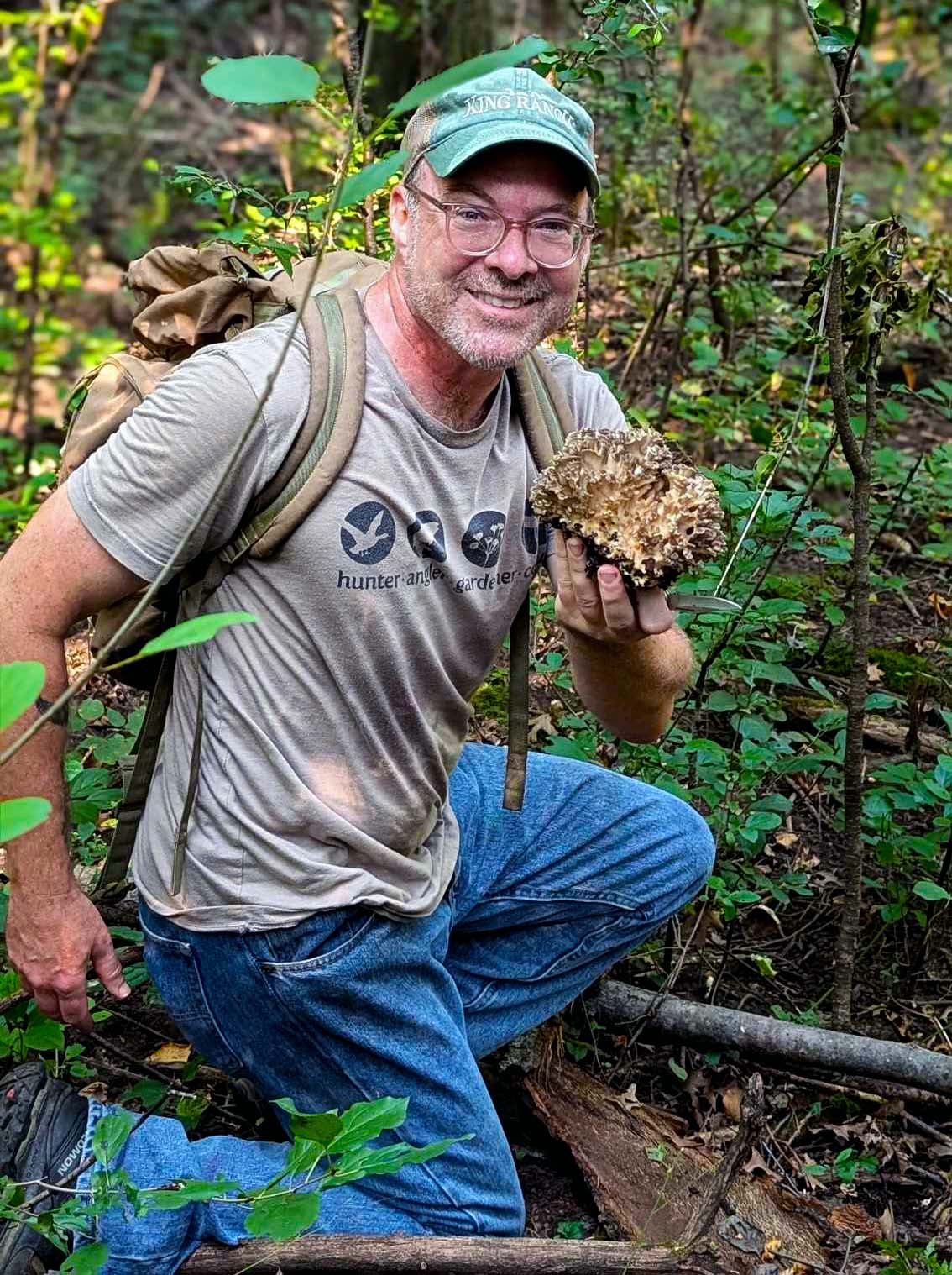 Hank holding a hen of the woods mushroom. 