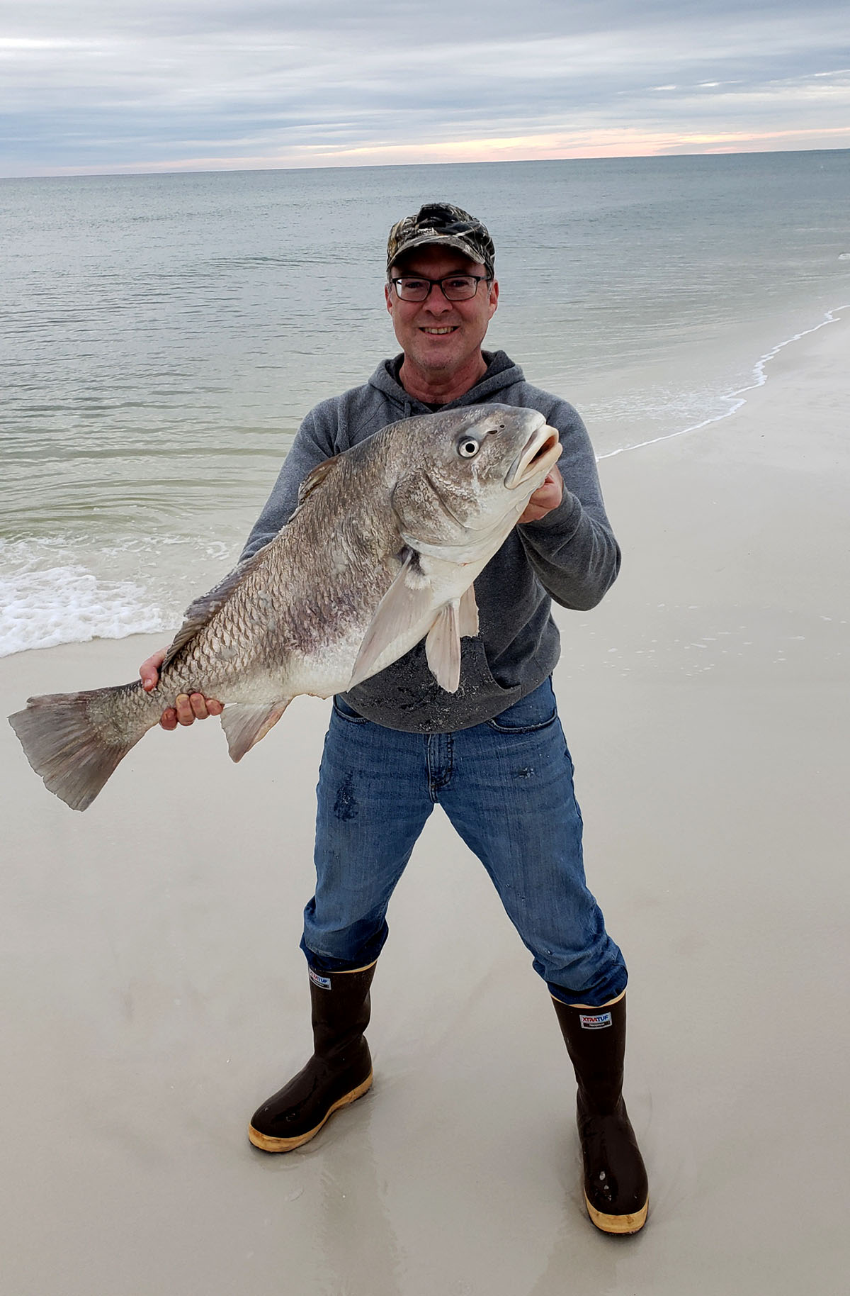 Hank holding a black drum in 2019. 
