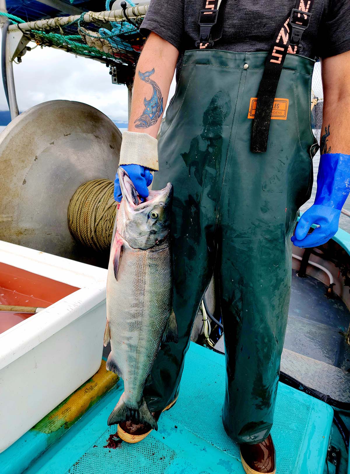 Hank holding a salmon in Alaska. 