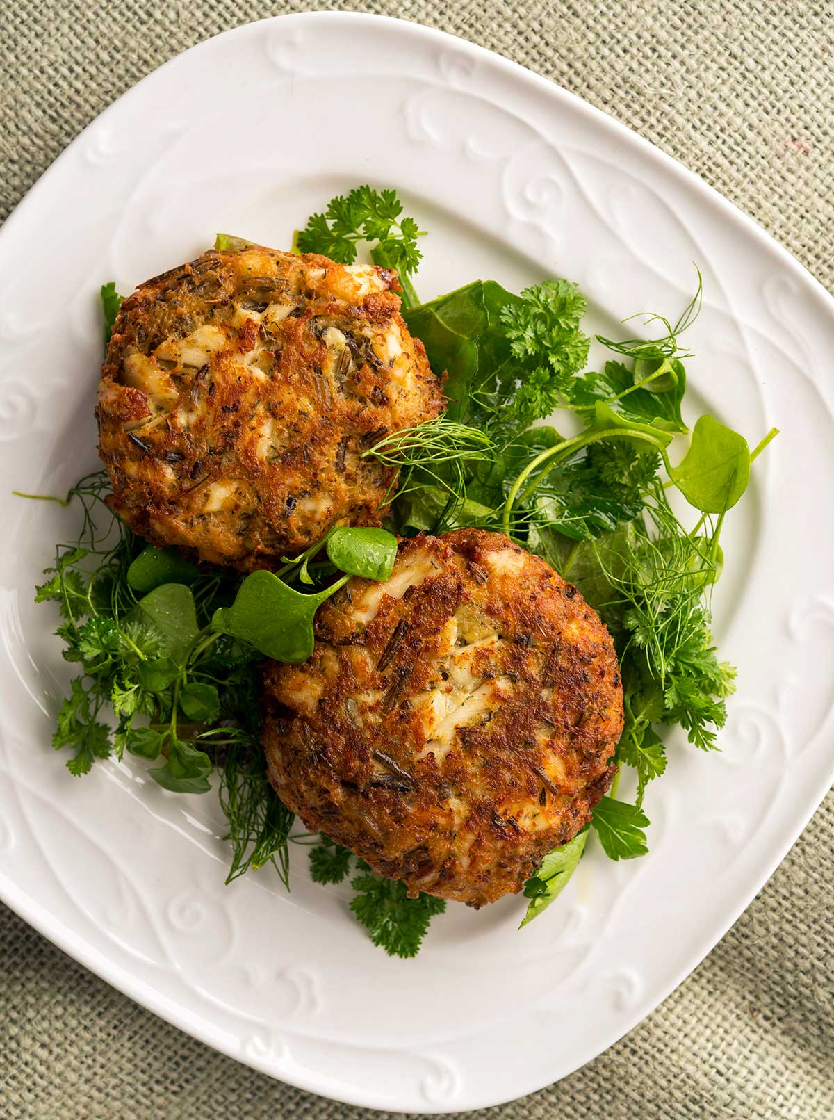 Fish cakes with wild rice on a plate. 