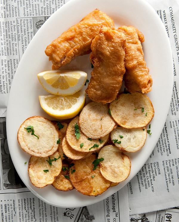 Beer battered fish and chips on a plate. 