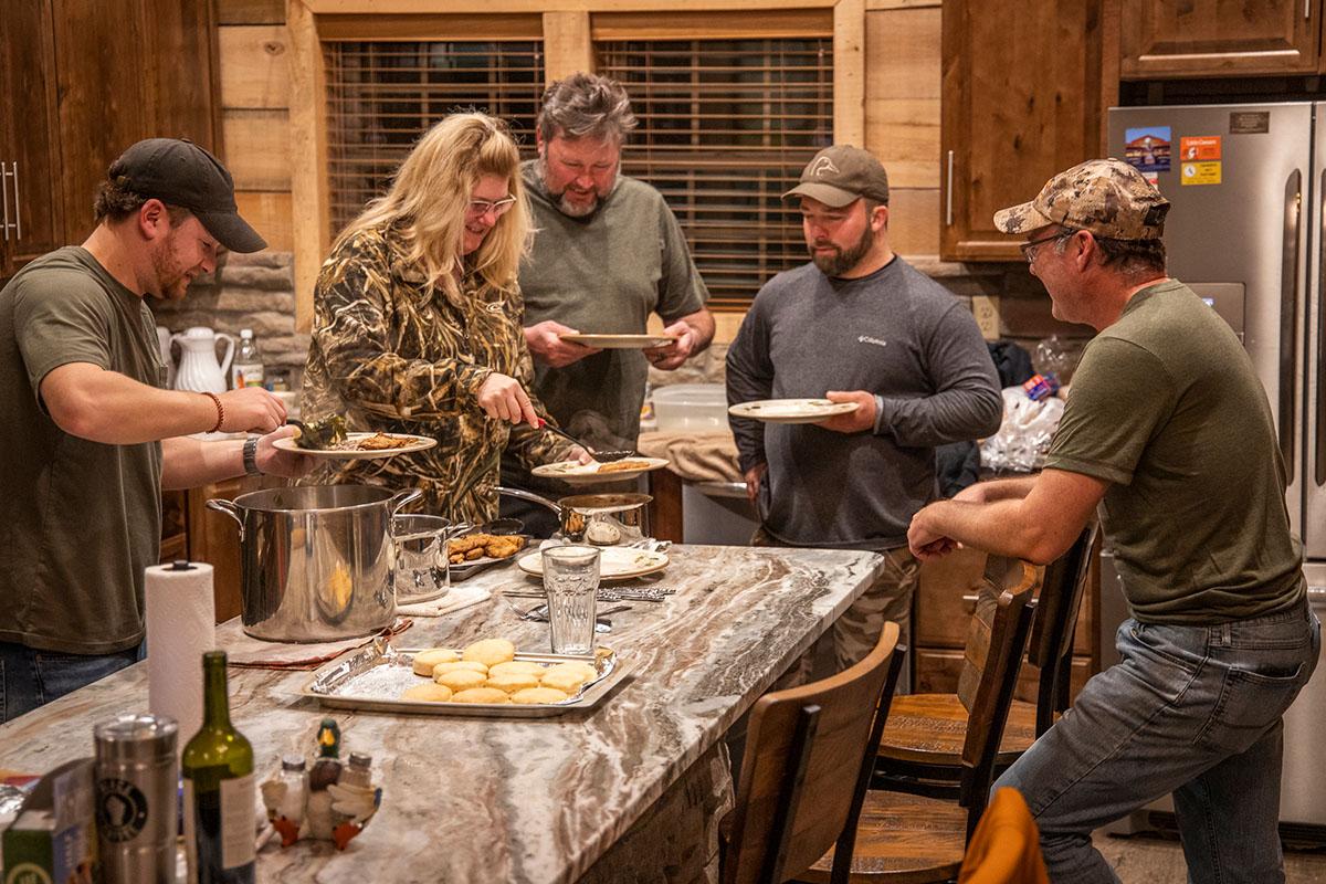 Hunters filling their plates at a culinatry hunt. 