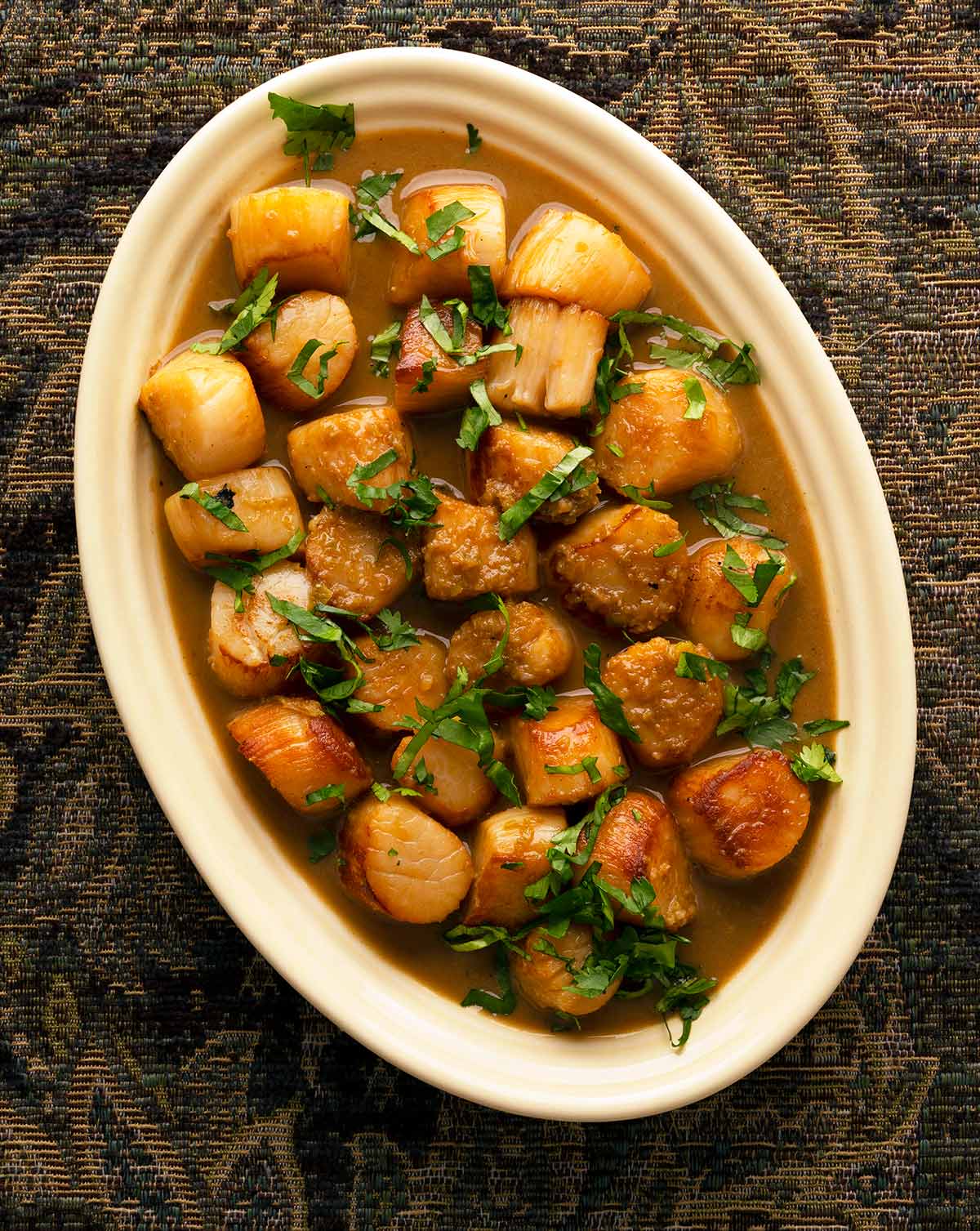 A platter of garlic butter scallops. 