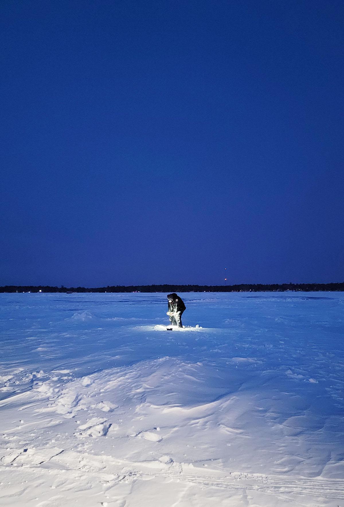 Drilling a hole in the ice on Lake Bemidji.