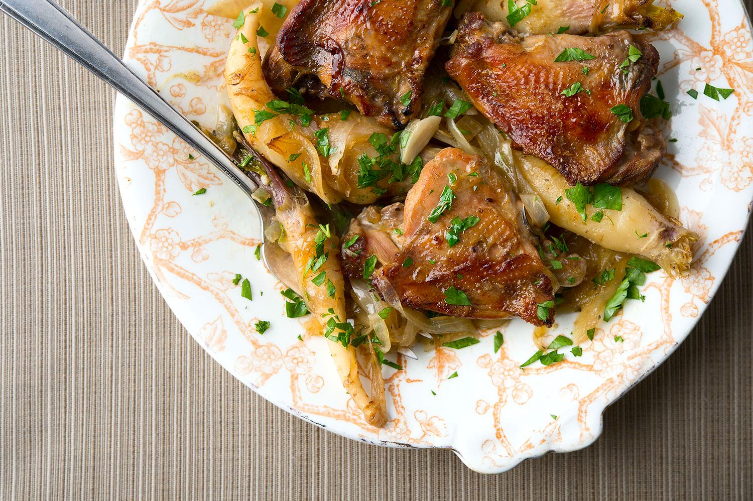 Pheasant thighs with garlic and root vegetables. 