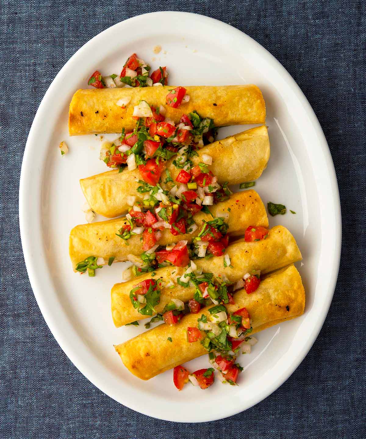 Tacos dorados on a plate. 