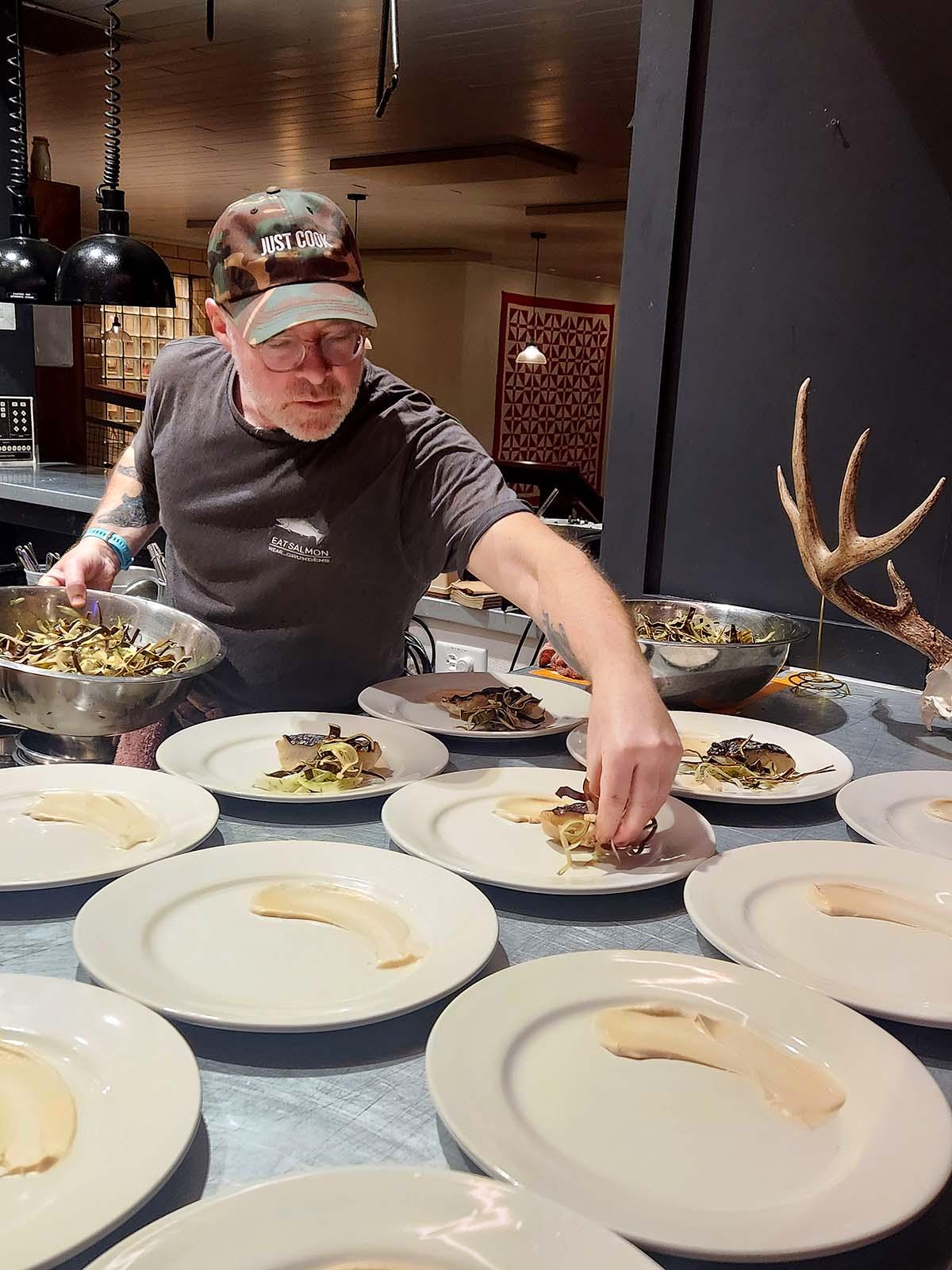 Hank Shaw plating food. 