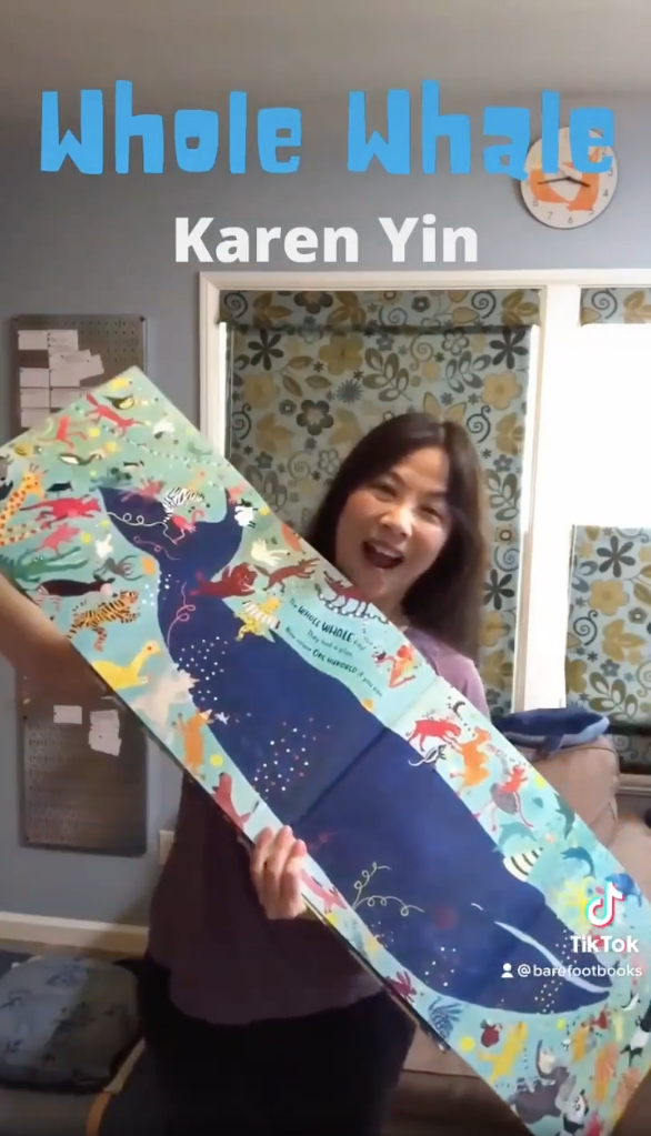 Screenshot of TikTok video with me, a light-skinned Chinese American woman, opening Whole Whale to the double gatefold, which shows the whole whale.