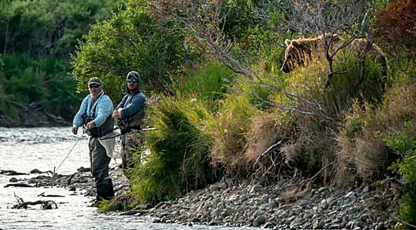 Photographer Catches Grizzly Bear Sneaking Up On Two Fishermen
