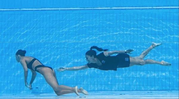 Coach Rescues Synchronized Swimmer During Competition