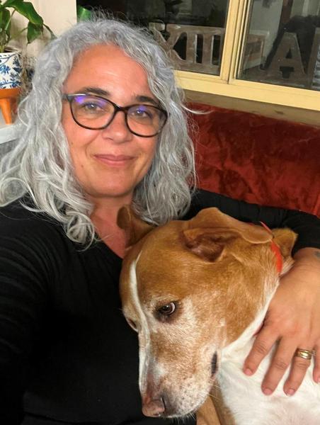 Ash holding her brown and white dog Dusty