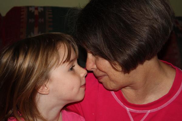 Grandmother and granddaughter nose to nose