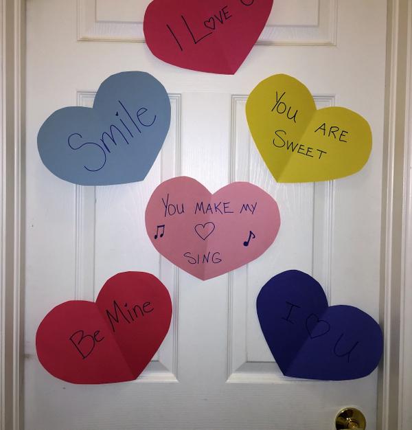 Large construction paper hearts on a door