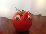 Happy shaped tomato with nose and googly eyes