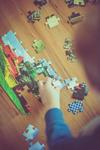 child putting puzzle together