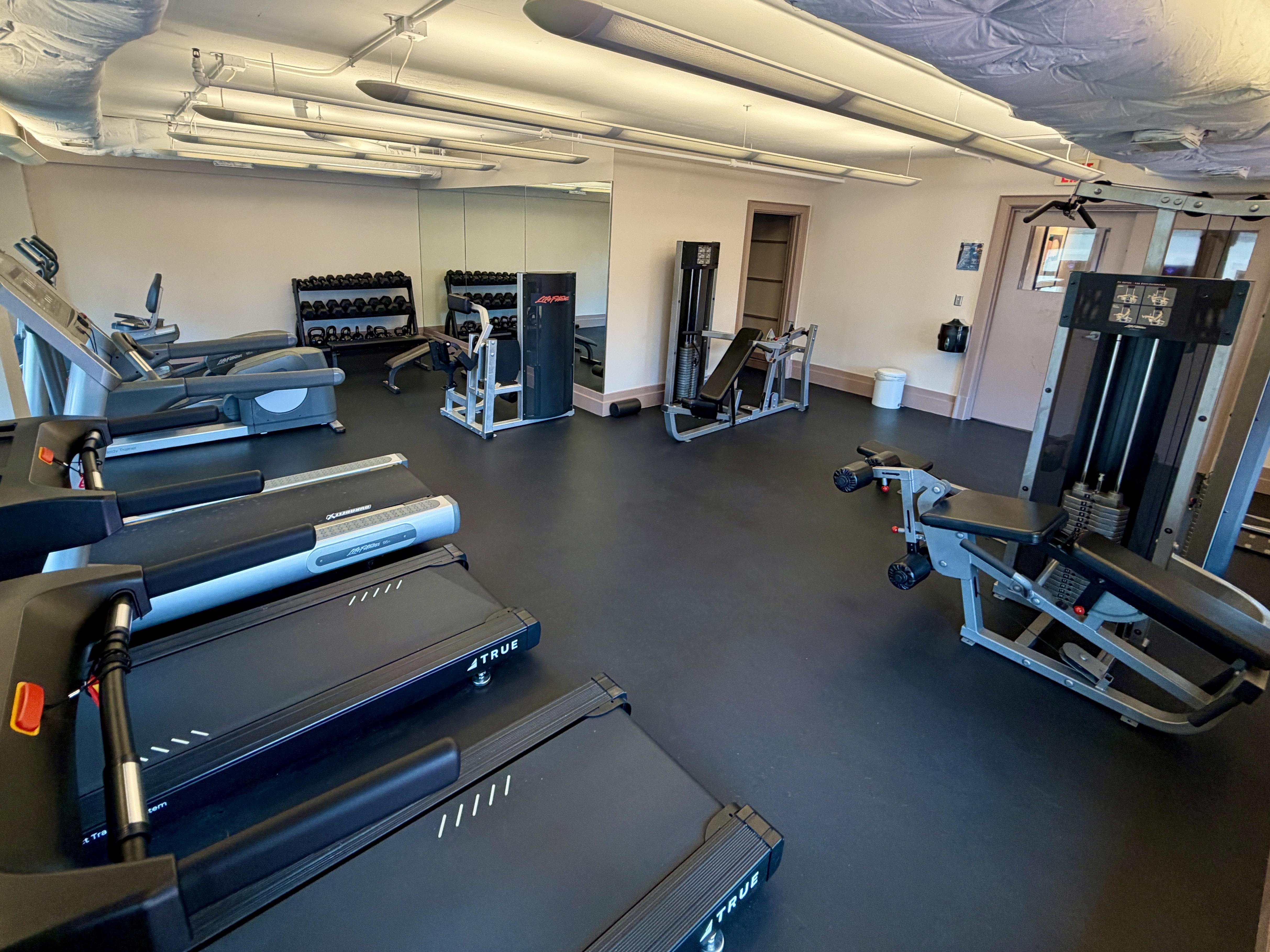 Fitness center with treadmills, weight machines, and free weights