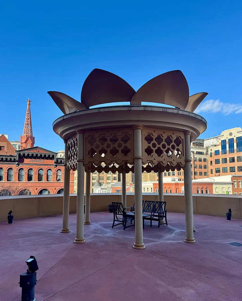 Iconic lotus pavilion on rooftop terrace with DC skyline