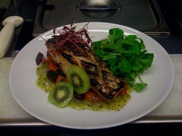 Roasted fish over root vegetables with watercress salad, kiwi and a bright citrus dressing