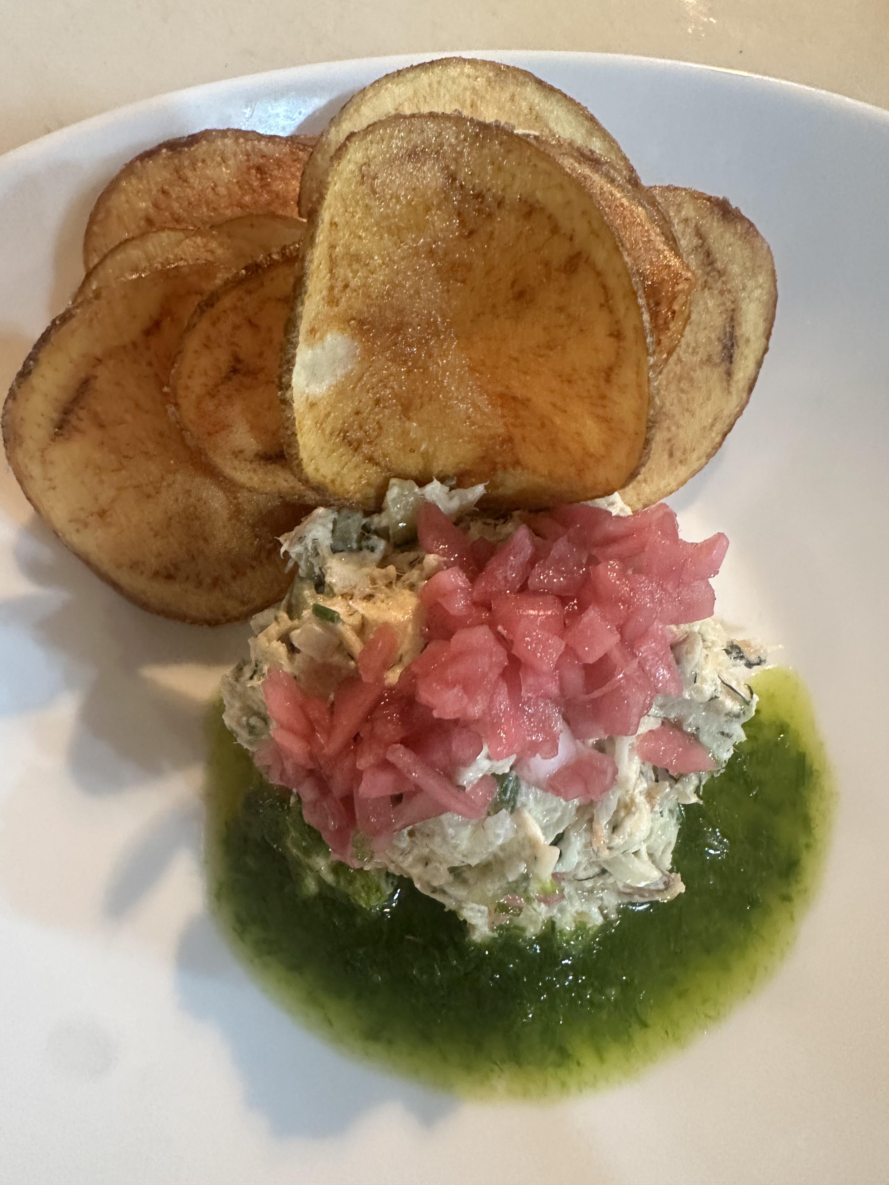 Smoked fish salad with pickled onion and herb oil served with crisp house-made potato chips