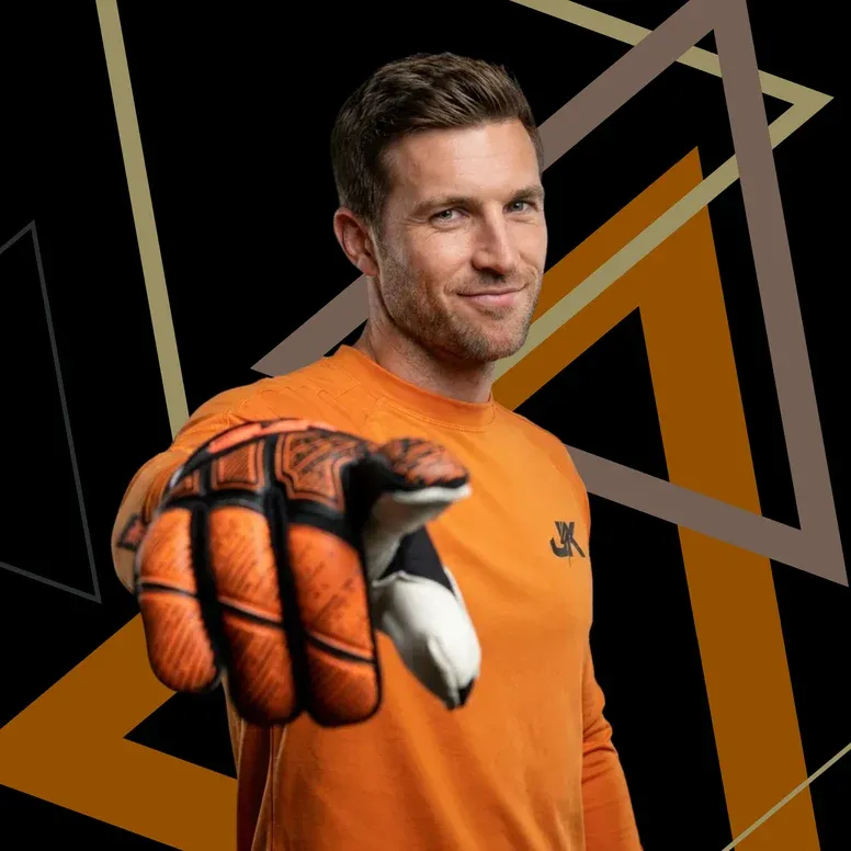 J4K sponsored goalkeeper holding out orange PRO glove