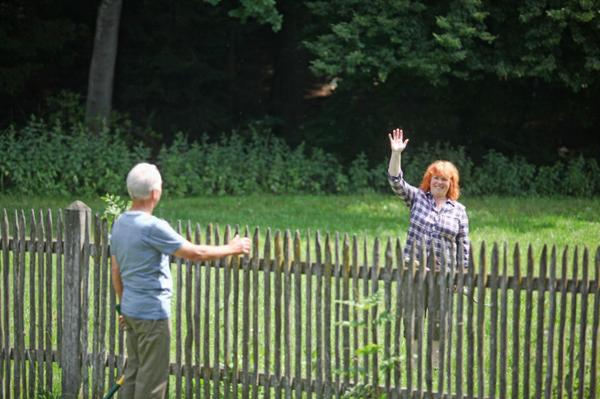 two people talking across a fence