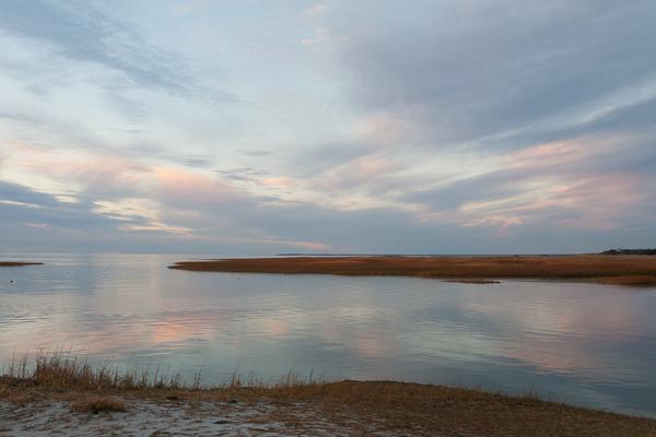 Sunset at Boat Meadow Beach, Eastham, MA Cape  Cod. Water and sky reflect with land floating in between.